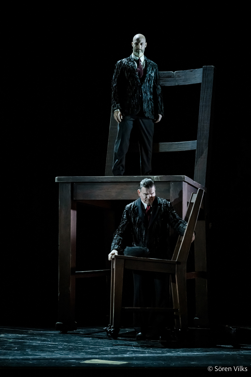 Dramatic moment: Porfiry Petrovich looms over Svidrigailov on a giant chair at Dramaten's 'Crime and Punishment